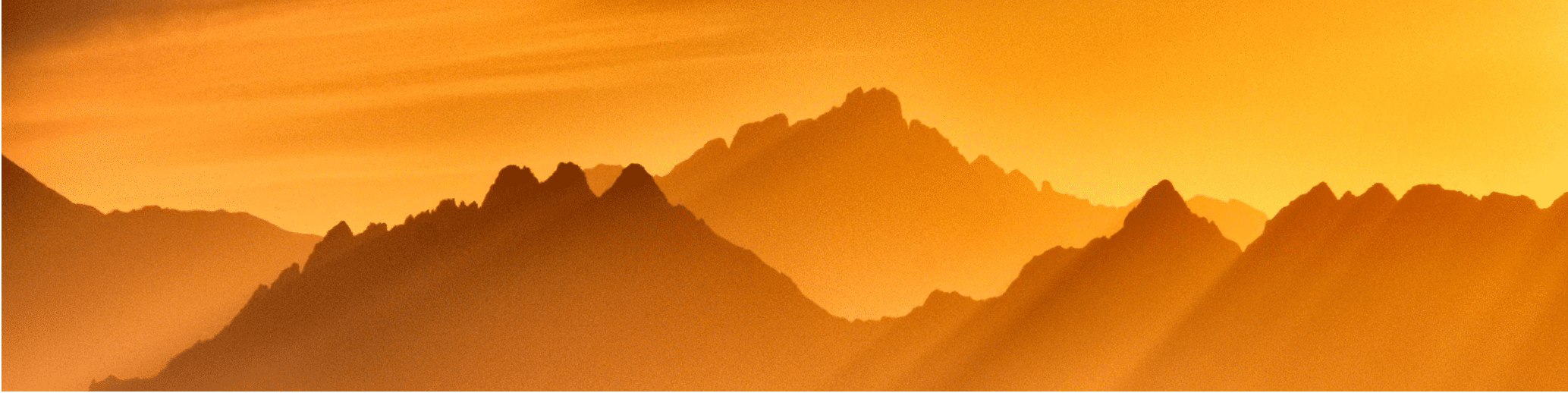 mountains through fog at sunset